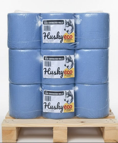 Stack of blue rolls with Husky Eco branding on a wooden pallet against a white background